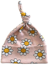 Pink baby beanie with a knot, decorated with white daisies and yellow centers.