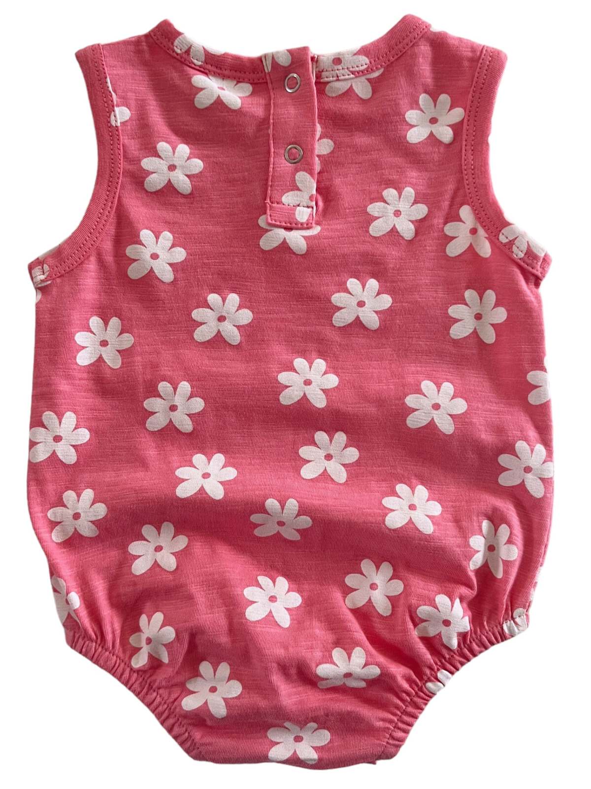 Pink baby romper with white flower patterns and snap buttons at the back. Perfect for warm weather.