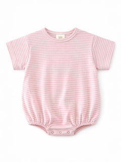 Light pink short-sleeve baby romper with a textured pattern and snap closures at the bottom.