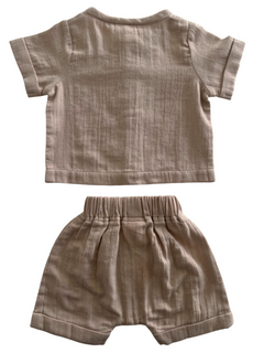 Light beige toddler outfit consisting of a short-sleeve top and matching shorts, displayed flat.