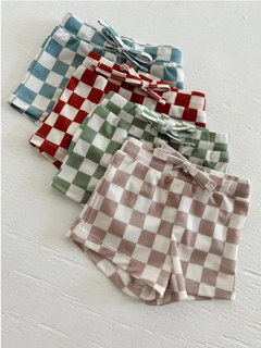 Colorful checkered shorts in blue, red, green, and brown arranged neatly on a white background.