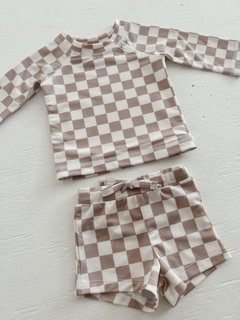 Tan and white checked swim set for kids, featuring a long-sleeve top and matching shorts.